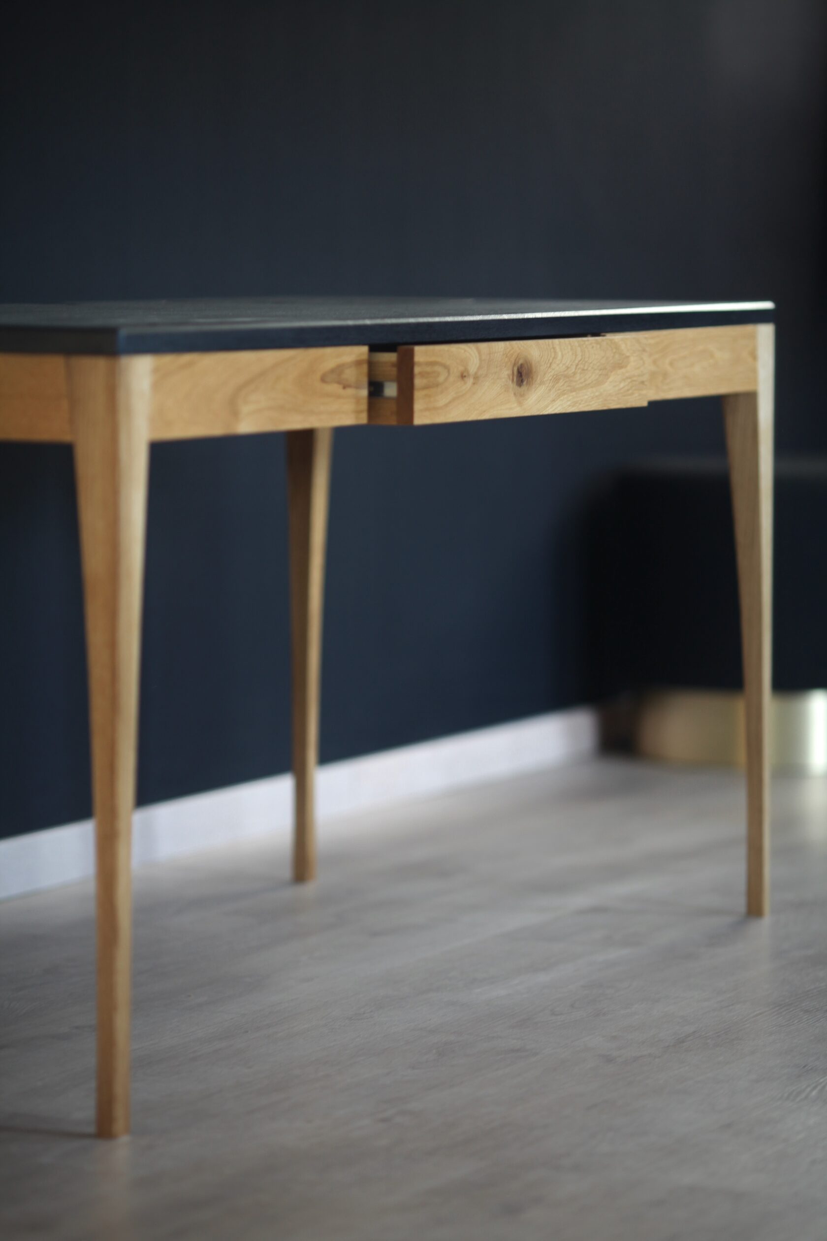 Adriana desk in oak, with a dark top and natural oak legs