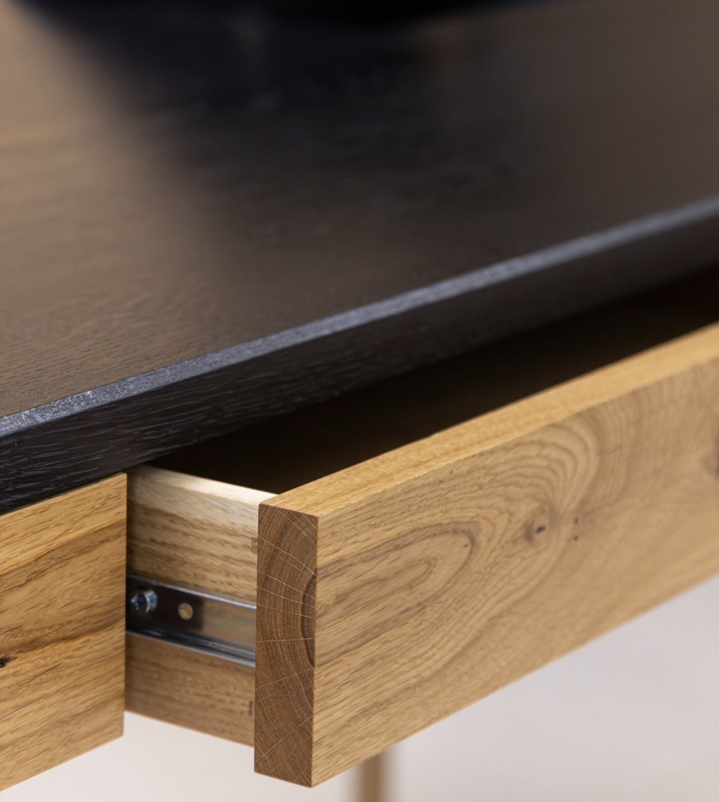 Close-up of the Adriana drawer on its runner, under the dark top