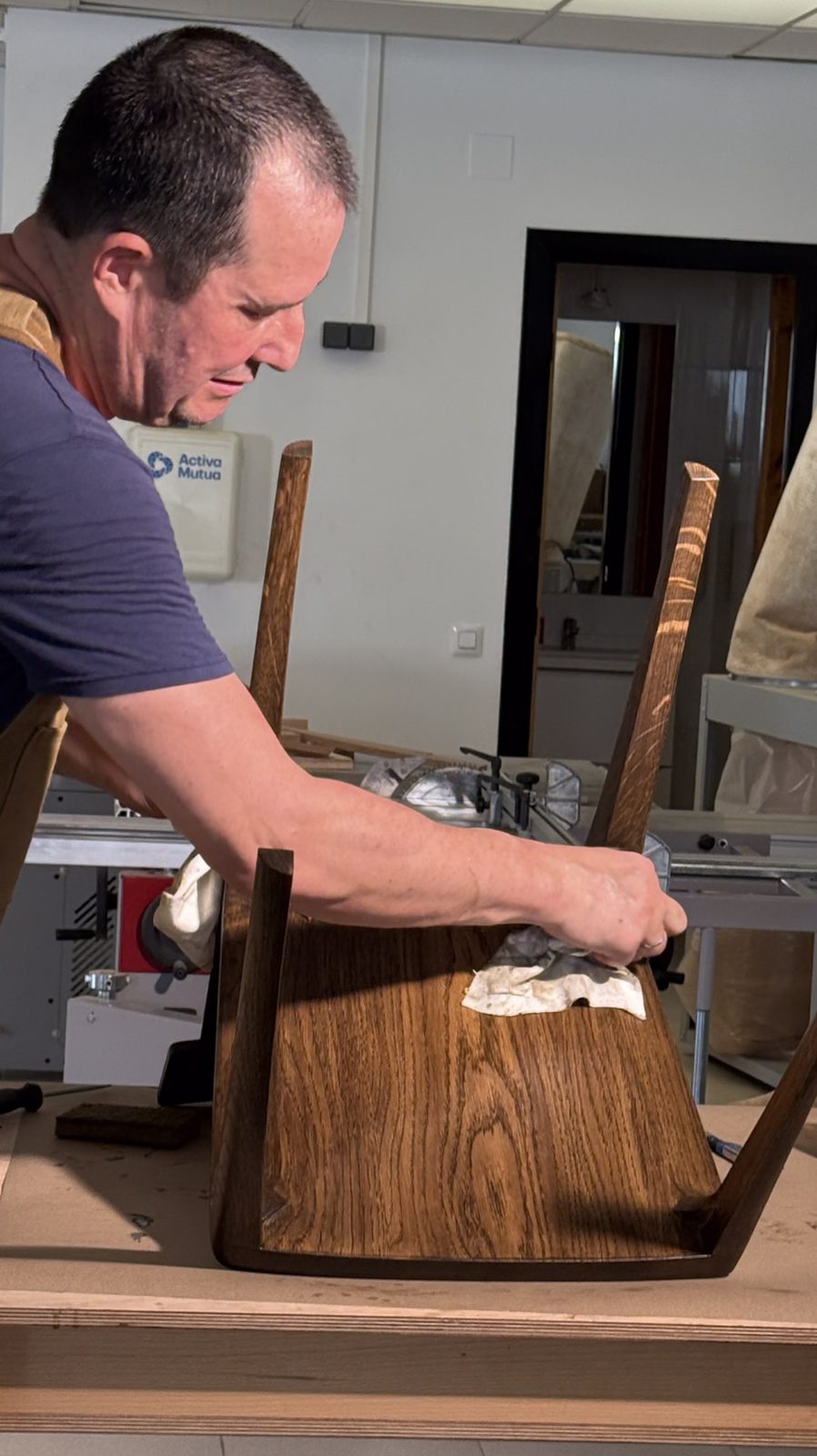 Finishing the seat of a Pilar chair by hand in the workshop